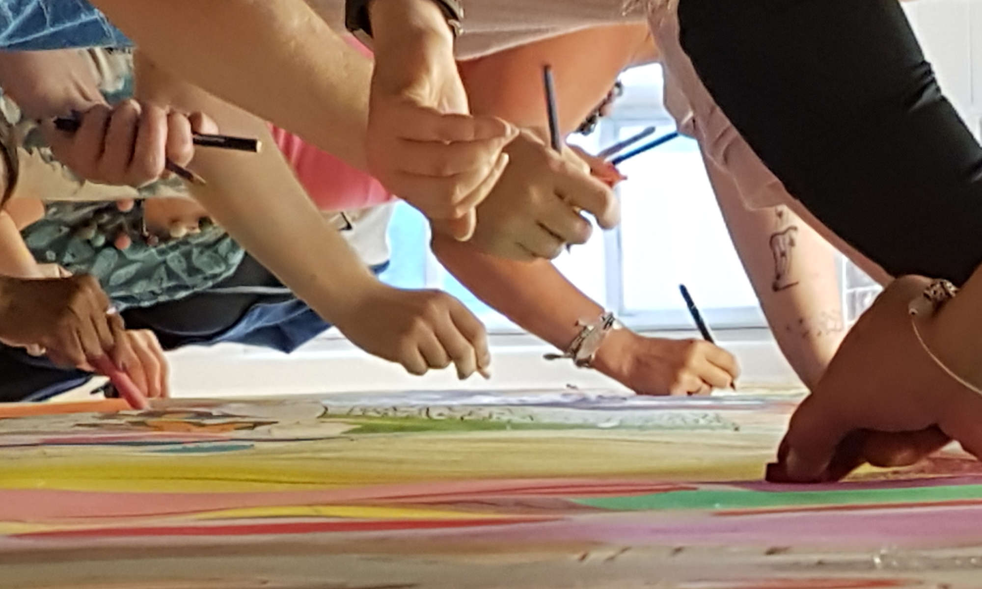 Image of many hands cocreating a collaborative 8gate art piece